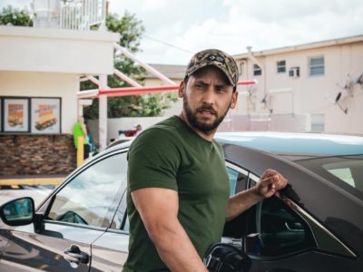 photo of a man fueling up his car